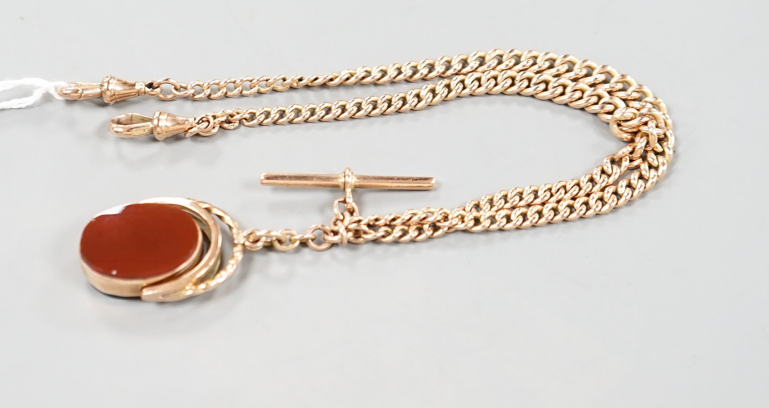 An Edwardian 9ct gold albert, with carnelian set spinning fob seal, chain 43cm, gross weight 36.5 grams.